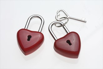 Small red padlocks with a heart-shaped key