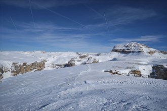 View of a ski resort piste and Dolomites mountains in Italy from Passo Pordoi pass. Arabba, Italy,