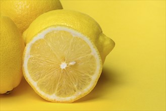 Lemon slice against yellow background, lemon