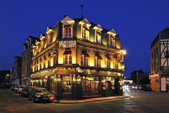 Illuminated facade of a hotel at night in Etretat, Normandy, France, Europe