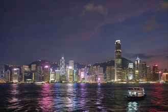 Hong Kong skyline cityscape downtown skyscrapers over Victoria Harbour in the evening illuminated