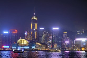 Hong Kong skyline cityscape downtown skyscrapers over Victoria Harbour in the evening illuminated