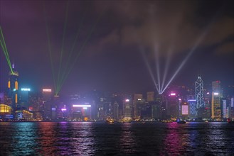 Hong Kong skyline cityscape downtown skyscrapers over Victoria Harbour in the evening illuminated