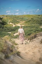 Tourist on sandy path through the National Park, Kennemerland National Park, Zandvoort, Netherlands