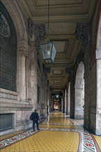 Arcaded walkway with mosaic floor from Palazzo della Borsa, built between 1907 and 1912, in Piazza