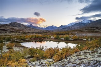 Mountains and lake in autumnal mountain landscape, Rondane National Park, Norway, Europe