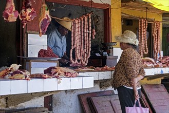 Malagasy butcher selling meat and sausages at burchery in the town Ambatolampy, Vakinankaratra