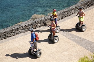 Tourists taking a ride with Segway Personal Transporters along the sea, Lanzarote, Canary Islands,