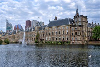 View of the Binnenhof House of Parliament and the Hofvijver lake with downtown skyscrapers in