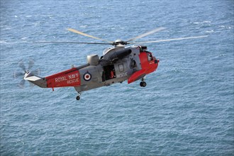 Royal Air Force, rescue helicopter in action above the sea, Cornwall, England, United Kingdom,