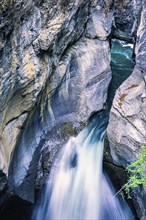 Beautiful waterfall in a canyon between the rock faces, Jasper National Park, Canada, North America