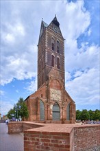 Ruin of St. Mary's Church with bricked-up ground plan and steeple, historic old town Hanseatic city