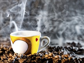 Espresso cup and rosted Coffee beans with some mist around