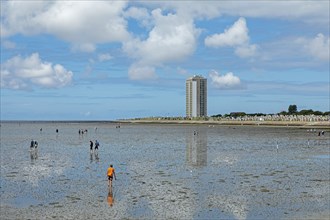 People on the mudflats, high-rise building, Büsum, Schleswig-Holstein, Germany, Europe