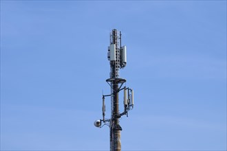 Mobile phone mast, transmission mast in front of sky, Hesse, Germany, Europe