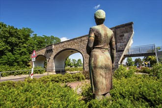 Sculpture Konerin in front of stone arch bridge Premnitz, Brandenburg, Germany, Europe