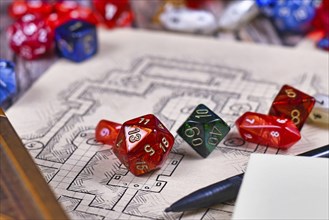 Colorful tabletop role playing RPG game dices on blurry hand drawn dungeon map