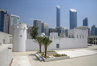 Old fort and museum Qasr al Hosn in front of skyscrapers, oldest building in Abu Dhabi City,