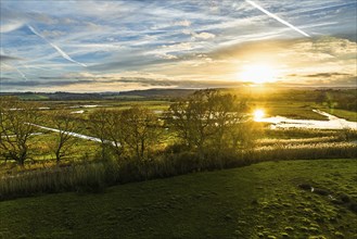 Sunset over Wetlands and Marshes in RSPB Exminster and Powderham Marshe from a drone, Exeter,