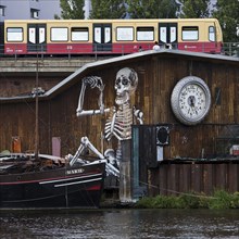 Scene on the Spree with ship and moving S-Bahn, close to Michaelbrücke, Friedrichshain, Berlin,