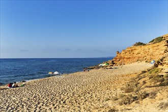 Tourists on the sandy beach, red rocks, holiday by the sea, Spiaggia di Scivu, Arbus, Costa Verde,