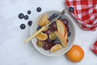 Various pieces of fruit in bowl, fruit salad