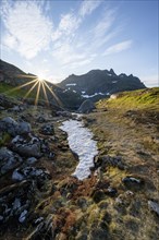 Mountain landscape at sunrise with sun star, Moskenesøya, Lofoten, Nordland, Norway, Europe