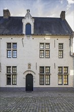 White 17th century beguine's houses and gate at the Beguinage of Aarschot in Flemish Brabant in