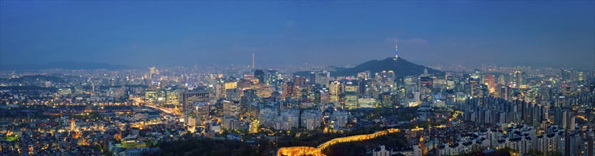 Panorama of Seoul downtown cityscape illuminated with lights and Namsan Seoul Tower in the evening