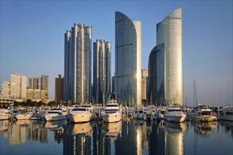 Busan marina with yachts, Marina city skyscrapers with reflection on sunset, South Korea, Asia