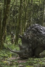 Diorama showing Neanderthal hunter chasing woolly rhinoceros (Coelodonta antiquitatis) at Prehisto