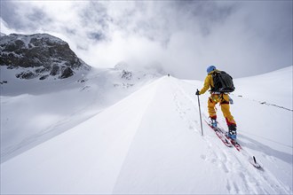 Ski tourers in a snowy mountain landscape, ascent to the Wildhorn, cloudy mood, high tour, Bernese