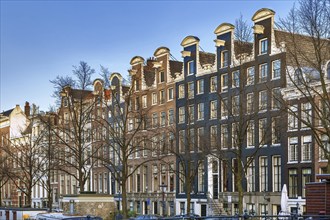 Historical houses on embankment in Amsterdam, Netherlands