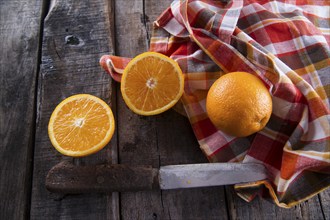 Lots of freshly picked oranges on dark table