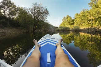 Kayaking in lake. POV of man kayaking in beautiful landscape. Aquatic sports during summer concept.