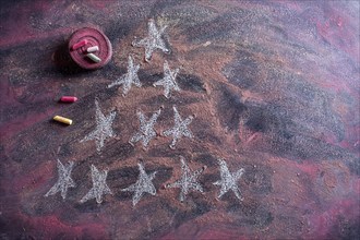 Small stylized christmas tree on blackboard with chalk