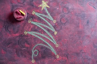 Small stylized christmas tree on blackboard with chalk