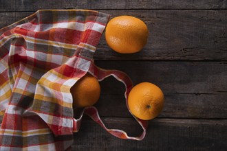 Lots of freshly picked oranges on dark table