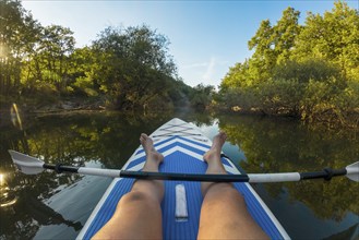 Kayaking in lake. POV of man kayaking in beautiful landscape. Aquatic sports during summer concept.