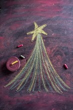 Small stylized christmas tree on blackboard with chalk