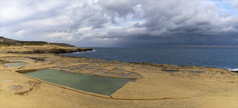 A panorama view of the salt pans in Xwejni Bay on the Maltese island of Gozo