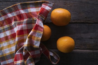 Lots of freshly picked oranges on dark table