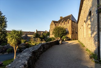 Picturesque narrow street of the medieval village of Locronan a sunny day of summer at evening