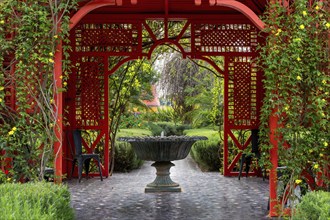 Marrakesh, Morocco, 24 March, 2024: fountain and red gazebo in the heart of the Anima Garden in