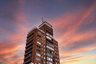 Madrid, Spain, October 16, 2021: Low angle view of old residential skyscraper against colorful