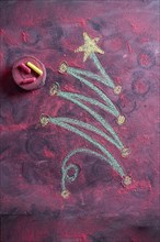 Small stylized christmas tree on blackboard with chalk