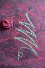 Small stylized christmas tree on blackboard with chalk