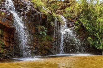 Waterfall among the rocks and vegetation in the Muaimii environmental reserve in the state of Minas