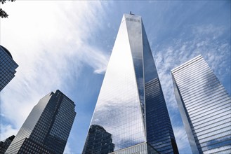 New York City, USA, June 20, 2018: One World Trade Center and other skyscrapers against blue sky in