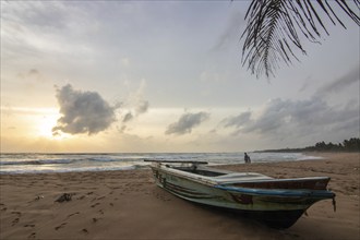 Landscape by the sea and sandy beach. A boat lies in the sand and adds a special touch to the